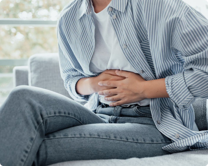 Man holding stomach considering risks of fundoplication