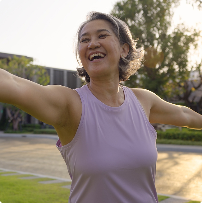 Woman with her arms outstretched outdoors