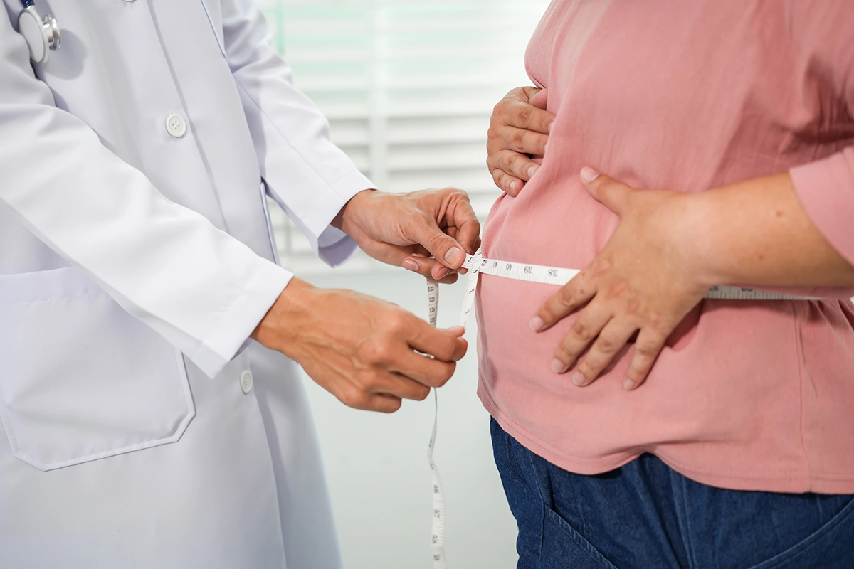 A medical professional attending to a patient as part of a weight loss consultation
