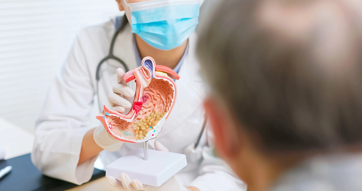 A doctor providing a patient with a consultation regarding gastrointestinal discomfort.