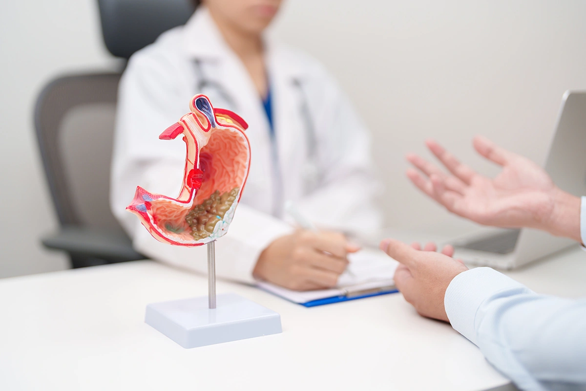 A patient visiting a doctor for acid reflux symptoms.
