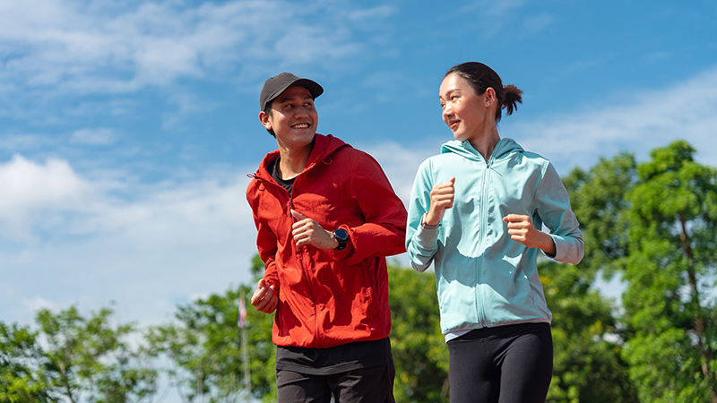 Asian couple jogging together