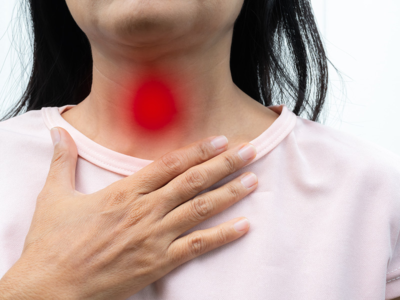 A woman suffering from acid reflux