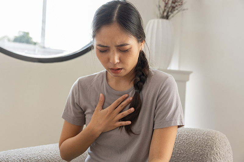 A woman suffering from acid reflux